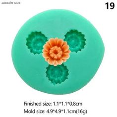 the mold is designed to look like an orange flower on top of green leaves and petals