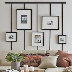 a living room filled with lots of furniture and pictures on the wall above it's coffee table