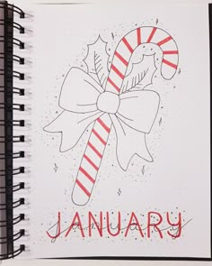 an open spiral notebook with a candy cane on it and the words january written in red ink