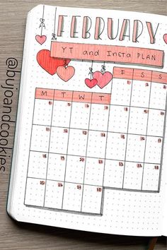 an open planner with hearts hanging from it