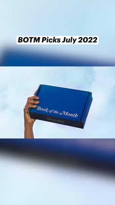 a person holding up a blue box with the words botm picks july 22, 2012