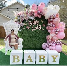 a baby shower is set up with balloons and letters in front of a backdrop that says baby