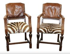 two chairs with zebra print upholstered on the back and sides, one in brown leather