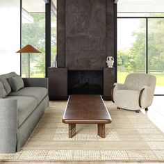 a living room with two couches and a coffee table in front of a fireplace