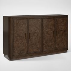 the sideboard is made from wood and has three doors