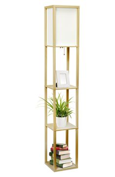 a tall wooden shelf with plants and books on it's sides, against a white background