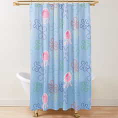 an octopus shower curtain in blue with pink and green tentacles on the bottom, against a white bathtub