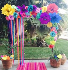 colorful flowers and streamers decorate an outdoor ceremony