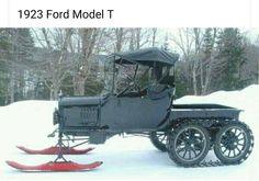 an old fashioned car is parked in the snow