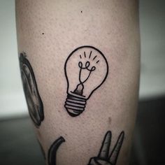 a tattoo on the leg of a person with a light bulb