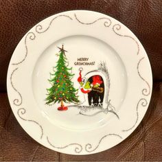 a white plate with a christmas tree on it and a santa clause holding a bag