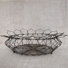 a metal wire basket with four sections on the bottom and one section in the middle