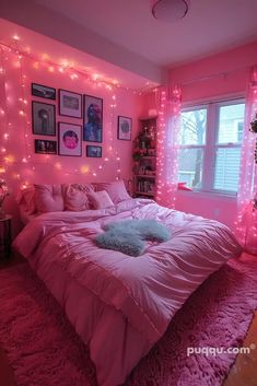 a bedroom with pink walls and lights on the ceiling, bed in front of window