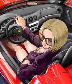 a woman sitting in the driver's seat of a red sports car