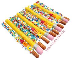 a bunch of birthday candles that are decorated with letters and sprinkles on them