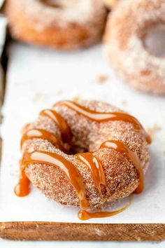 a doughnut covered in icing and drizzled with caramel sauce