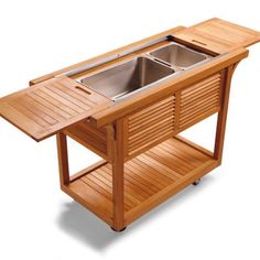 a wooden table with two sinks on it and an open shelf underneath the sink for storage