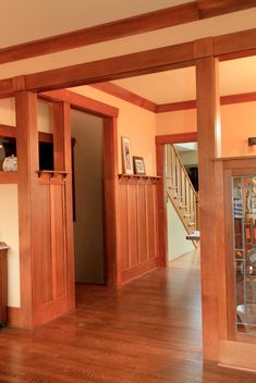 an empty living room with wood floors and built in cabinets