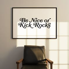 a chair sitting in front of a wall with a sign above it that says be nice or kick rocks