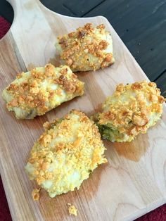 four pieces of food sitting on top of a wooden cutting board