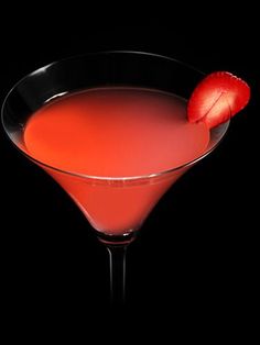 a red drink in a martini glass with a strawberry on the rim