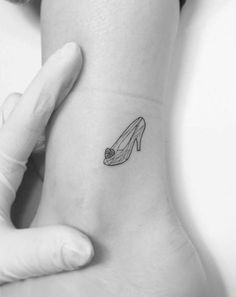 a woman's foot with a shoe tattoo on her left side ribcage