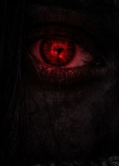 an evil looking person's eye with red light coming from the iris in it