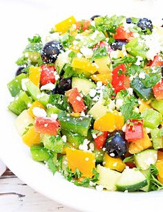 a white bowl filled with fruit and vegetables