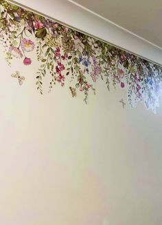 the wall is decorated with flowers and butterflies