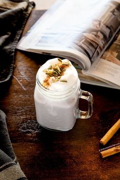 there is a book and some cinnamon sticks on the table