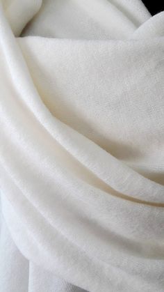 a close up view of a white fabric with very thin folds on the top and bottom