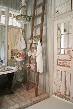 a bathroom with a ladder leaning up against the wall next to a bathtub and sink