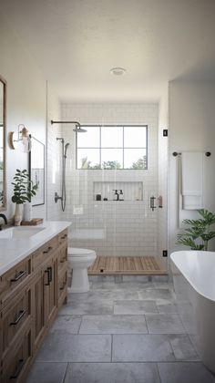 a bathroom with a tub, sink, and toilet in the middle of it's tiled floor