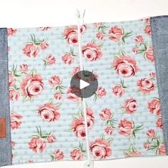 the video is showing how to sew an applique with denim and pink roses