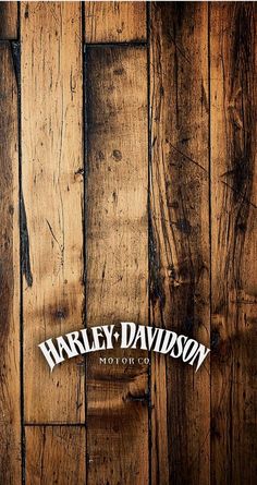 a wooden wall with the words harley davidson written in white on it's side