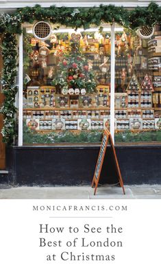 the front window of a store with christmas decorations on it and an easel in front