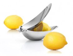 two lemons in a silver bowl and one is cut in half with a knife