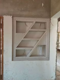 an unfinished room with some shelves in it