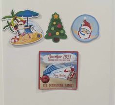 magnets on the side of a refrigerator decorated for christmas