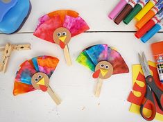 paper plate turkeys and craft supplies laid out on a table