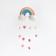 a rainbow mobile with hearts hanging from it's sides and a cloud in the middle