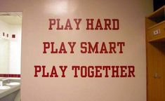 there is a sign that says play hard, play smart, play together on the wall