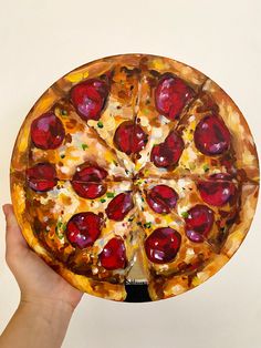 a hand holding up a pizza with cherries on it