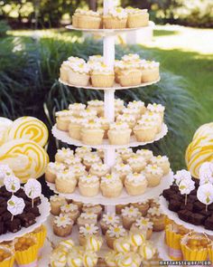 a table topped with lots of cupcakes and cakes