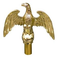 a golden eagle statue on top of a metal pole