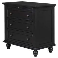 a black dresser with three drawers and two knobs on the bottom, in front of a white background