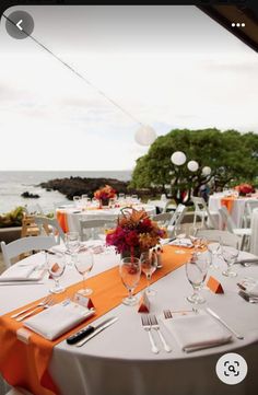 an outdoor dining area with tables and chairs set up for a formal function by the ocean