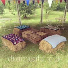 hay bales are stacked on top of each other in the grass under a tent