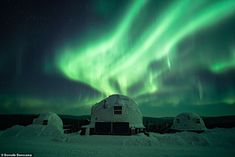 the aurora bore is shining brightly in the sky above an iglooy cabin