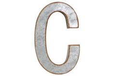 the letter g is made out of metal and has an aged look to it's surface